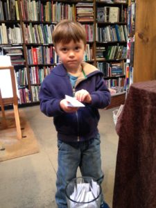 This serious helper pulled the winning entries from the hat.  